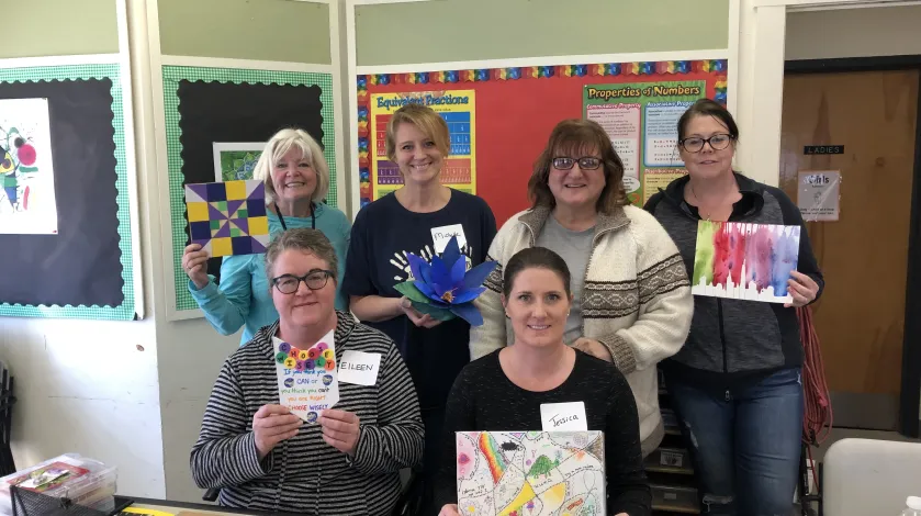 South Shore Medical Center Colleagues holding artwork